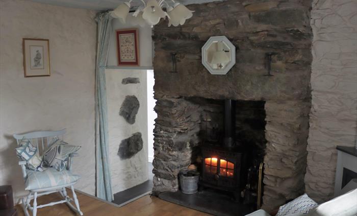 Two steps down to ground floor kitchen/dining area, utility room. Shower Room, Double Bedroom. Fuel for stove provided, no charge.